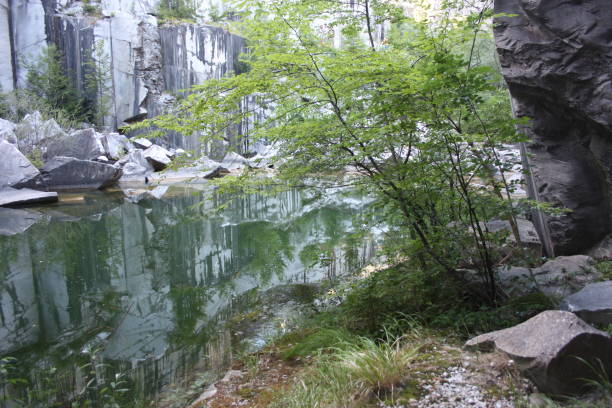 istock small natural lake inside a marble quarry in mountain in apuan alps 1255244021
