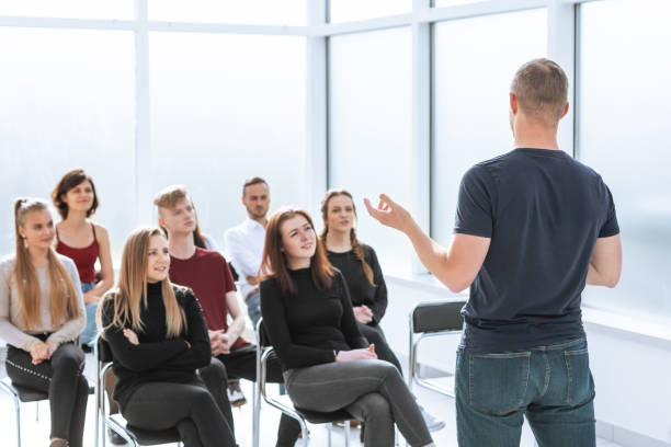 istock speaker makes a report for a group of diverse young people 1255245421