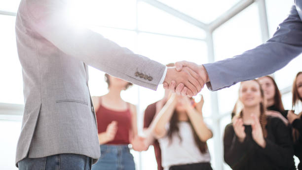 istock creative young business people shaking hands with each other 1255245436