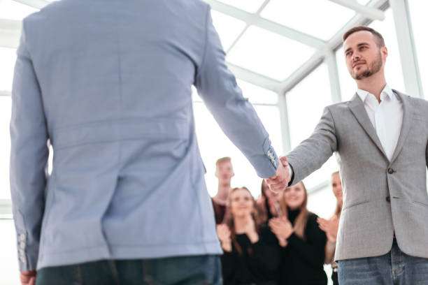 istock confident young business people meet each other with a handshake 1255245442