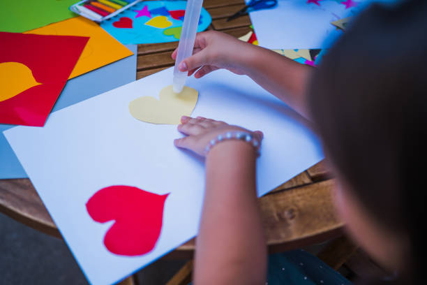 istock Girl enjoy using glue and doing arts 1255249219
