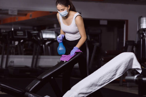 istock Gym stuff spraying sanitizer against corona 1255250320