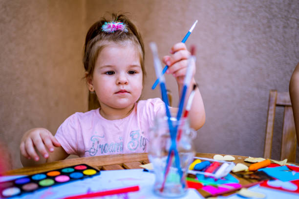 istock Little girl painting 1255250434