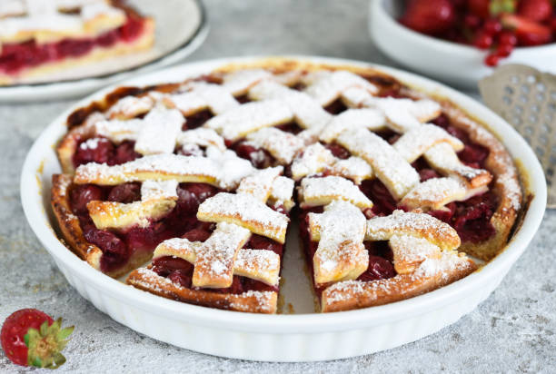 istock Cake with cherries and icing sugar on a concrete background. Sliced Cherry Pie. 1255252133