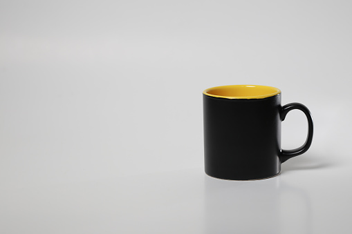black inside yellow coffee cup on white isolated background