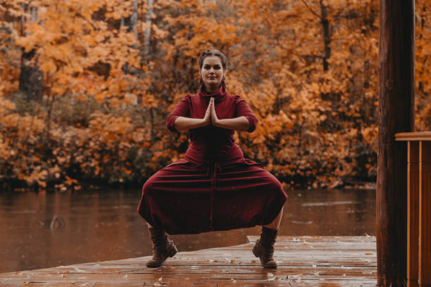 istock Plus size girl doing yoga in autumn park. 1255254570