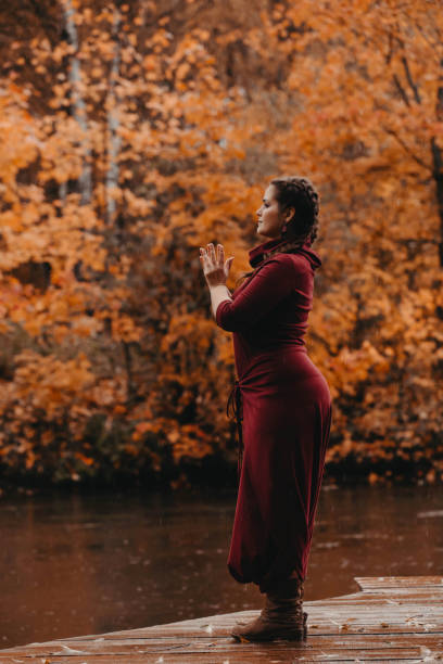 istock Plus size girl doing yoga in autumn park. 1255254572