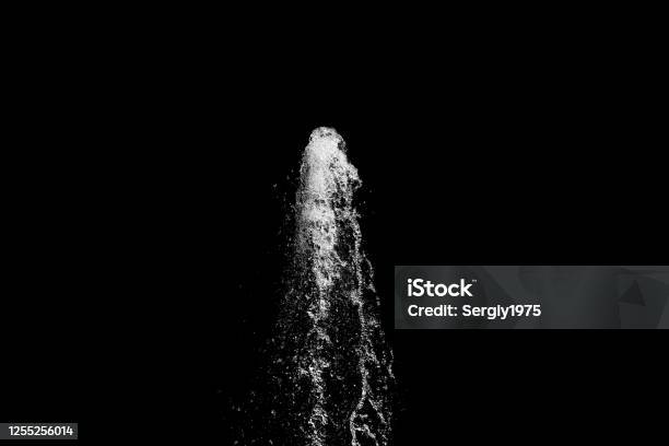 Water Jet Rising Up And Splashing On A Black Background Stock Photo - Download Image Now