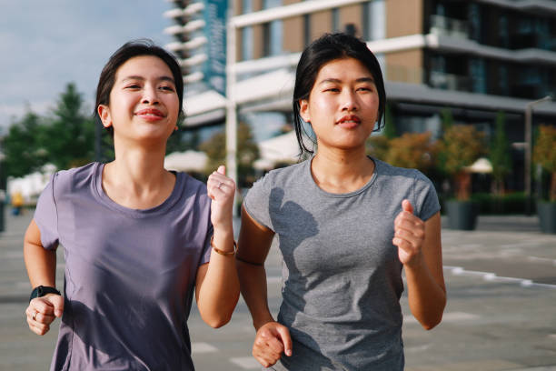 istock Two city girls going for a jog together 1255256172