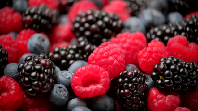Berries rotation background. Healthy eating, Vegan food, Diet. Raspberry, Blackberry, Blueberry close-up