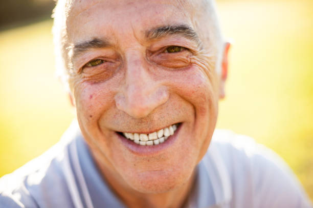 istock Smiling happy senior man in natural defocused background 1255256286