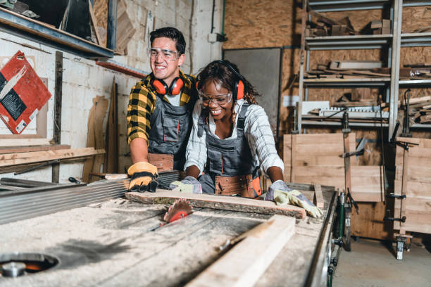 istock Afro Woman as carpenter working with circular saw at workshop 1255257882