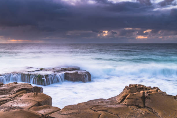 istock Cloudy sunrise from Rock Platform at North Avoca Beach on the Central Coast, NSW, Australia. 1255257897