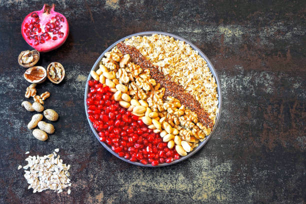 istock Breakfast bowl of oatmeal with nuts and pomegranate. 1255257931