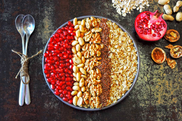 istock Breakfast bowl of oatmeal with nuts and pomegranate. 1255257943