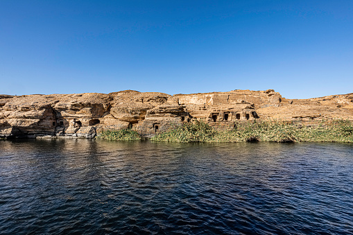 View of Gebel el Silsia Mountain Quarry Tombs while on a Nile river cruise between Edfu and Aswan.