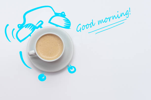 Good morning  Creative idea coffee cup alarm clock on white background. From top view.