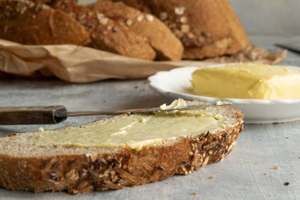 istock Whole oat sliced bread and fresh butter. Healthy eating concept 1255261733