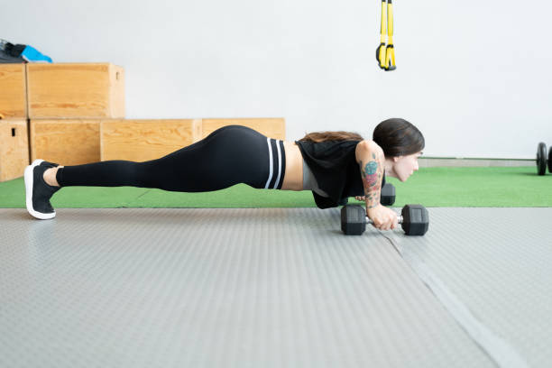 istock Young Woman Doing Workout At Heath Club 1255264163