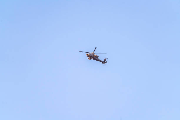 istock Helicopter or chopper flying in a blue sky 1255267450
