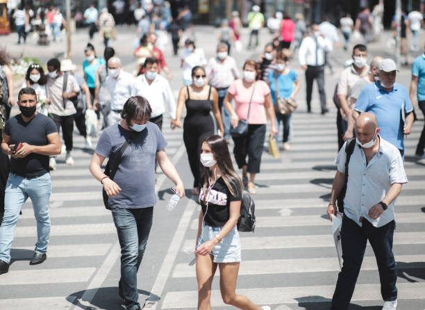 New Normal Concept View From Turkey Ankara, Turkey: July 09, 2020: General view from the road cross for pedestrians, people are walking according to new normal concept regulations. covid crowd stock pictures, royalty-free photos & images
