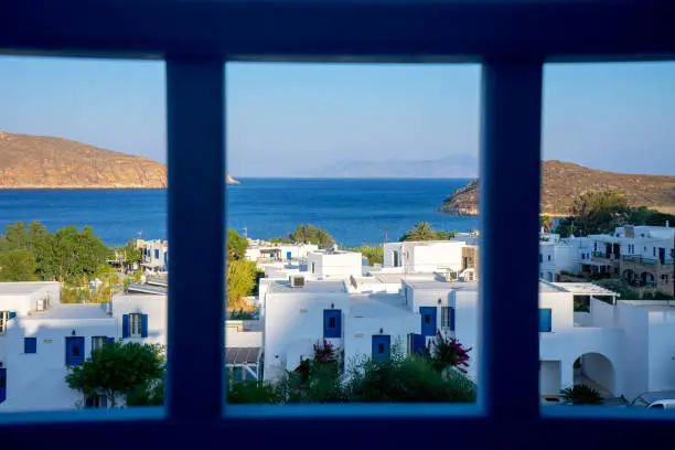 Typical Cycladic island sea view with whitewashed houses, blue sea and bright skies