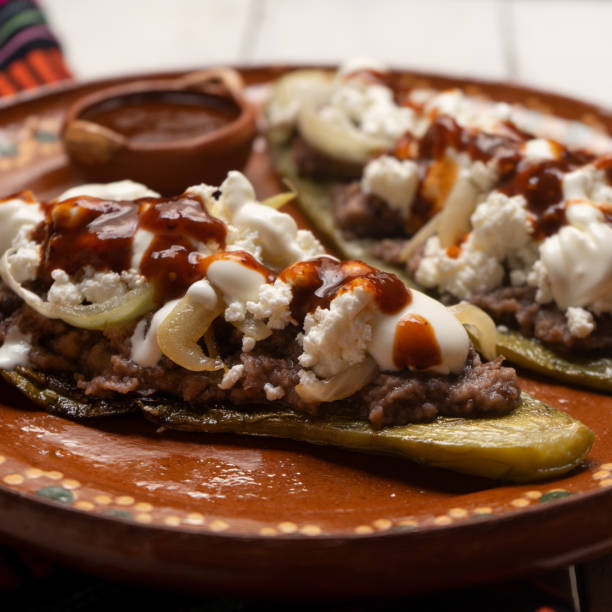istock Mexican nopal cactus huaraches with cheese and beans on white background 1255270516