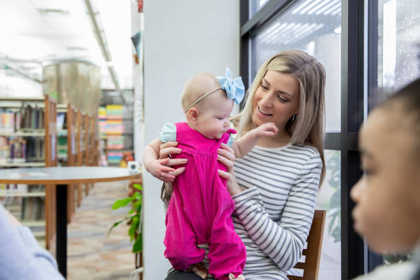 istock Mother holds baby while attending a mother's support group 1255270736
