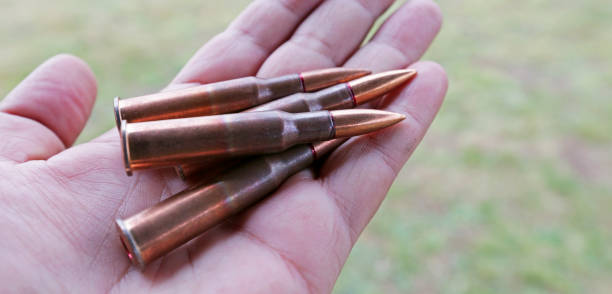 istock Patrons and ammunition on the table and the man's possession. 1255271950