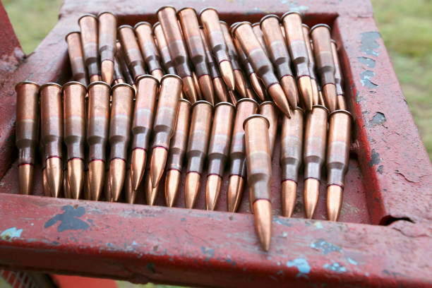 istock Patrons and ammunition on the table and the man's possession. 1255271957