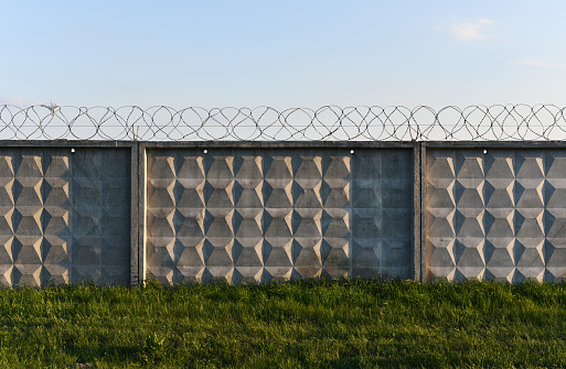 reinforced concrete fence with barbed wire of prison