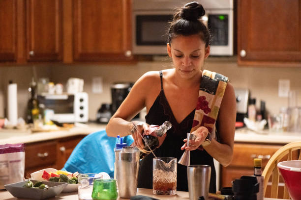 istock 30 Year Old Hispanic Woman Bartender Making Drinks at Home in Florida USA 1255274106