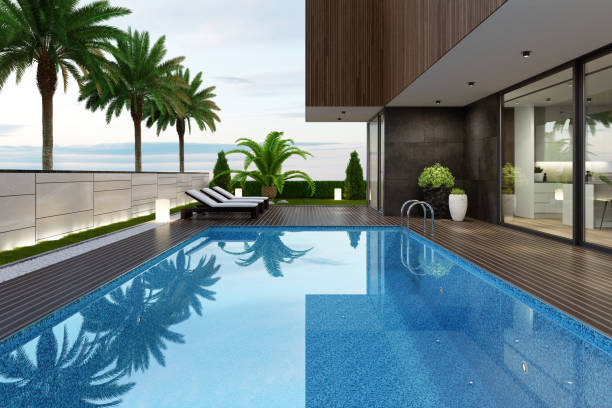 luksusowa willa przy plaży z basenem i palmami na letniej scenie zachodu słońca - luxury house villa swimming pool zdjęcia i obrazy z banku zdjęć