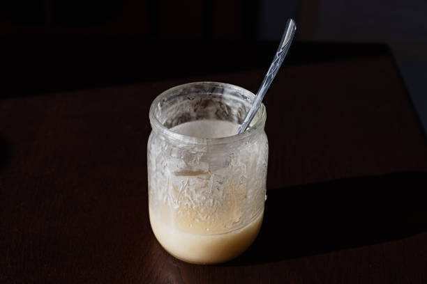 istock dirty jar stands on  table, not washed dishes with  spoon inside 1255275962