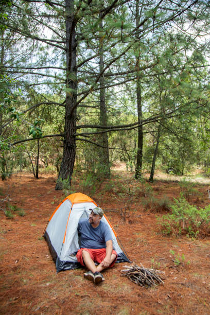 istock man camping in the woods 1255275981