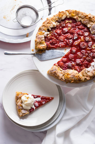 istock Delicious baked rustic strawberry pie on white marble background, top view 1255278042