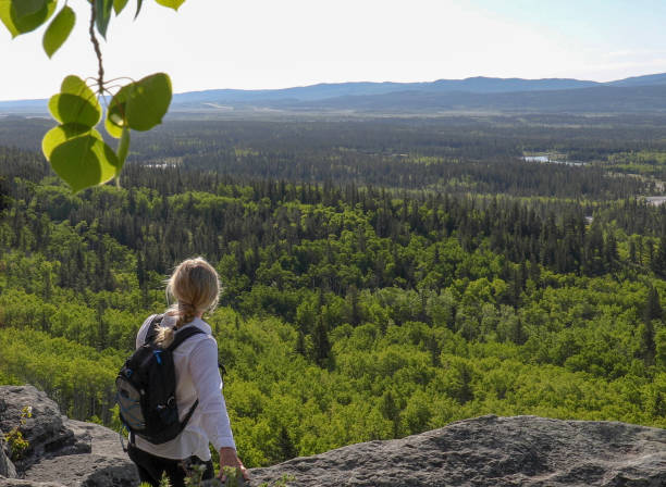 istock Female hiker relaxes on mountain ridge 1255279879