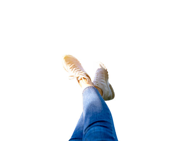 Female feet with white shoes and sky. copy space for advertisements, logos or texts