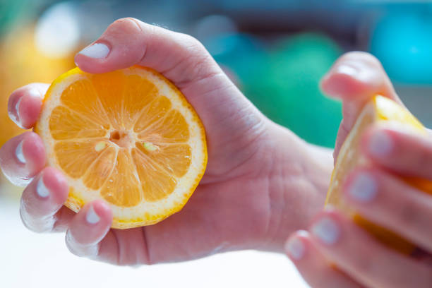 istock Woman Holding  an lemon. 1255285452