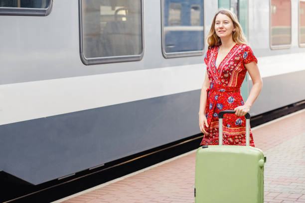 istock girl with a suitcase at the train station 1255287416