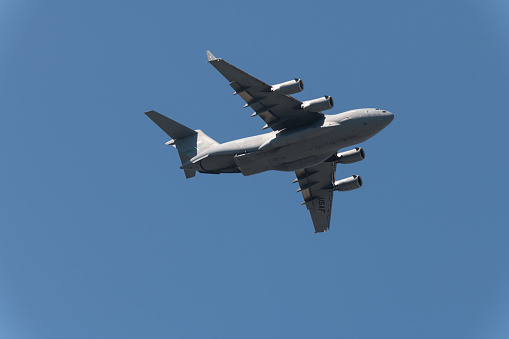 Seattle, USA – May 8, 2020: Late in the day an Airforce Boeing C-17 Globemaster flying over seattle to support frontline workers during the covid-19 pandemic and stay at home order.
