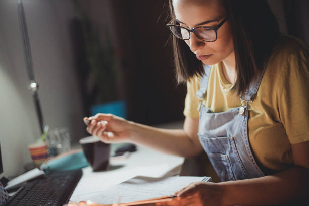 istock Young woman studying at home 1255293351
