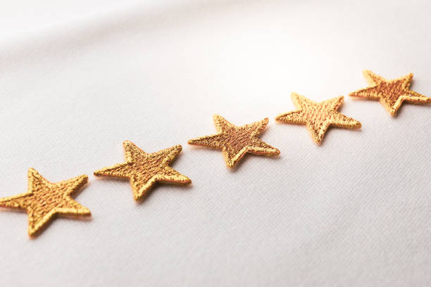 five gold stars embroidered on white cloth - first class star shape rank gold imagens e fotografias de stock