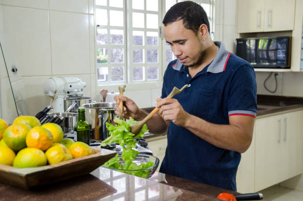 istock Man cooking lunch at home 1255299305