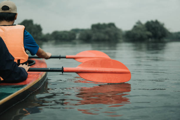 istock Asian family kayaking at river 1255302160
