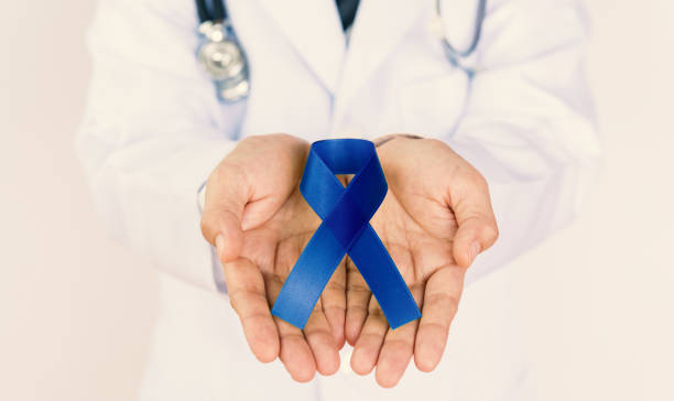 istock Doctor Holds Blue Ribbon 1255318230