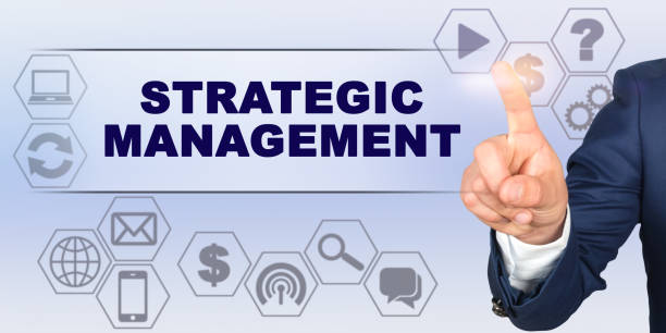 istock Businessman touching virtual screen with his finger. Screen caption - STRATEGIC MANAGEMENT 1255326091
