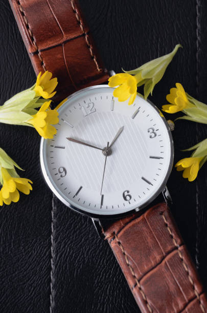 istock Watch with small yellow flowers 1255326763