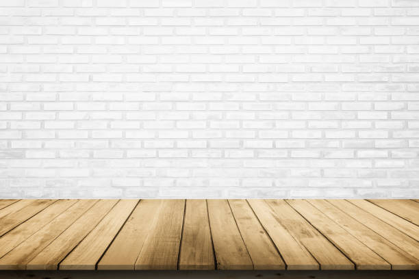 istock Empty wooden table top on white brick wall background, Design wood terrace white. Perspective for show space for your copy and branding. Can be used as product display montage. Vintage style concept. 1255329256