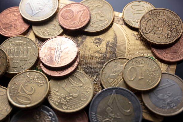 istock Golden dollar and EURO coins 1255329295